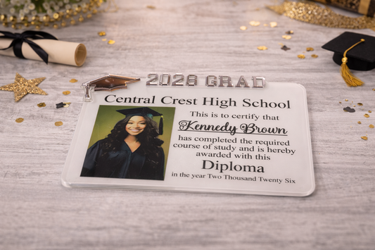 Graduation certificate for Central Crest High School with a photo of a graduate and confetti on a wooden surface.